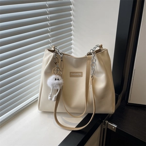 Fashionable creamy white PU leather tote bag with silver chain strap and fuzzy charm