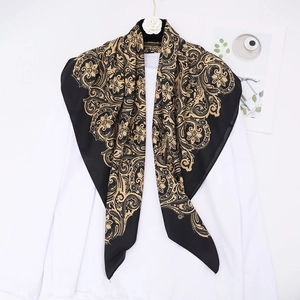 Classic black and gold paisley silk satin square scarf displayed on an elegant hanger