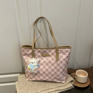 Pink and white checkered tote bag with leather handles and a plush bear pendant