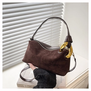 Close-up of matte coffee suede Boston bag with gold chain strap and leather texture details
