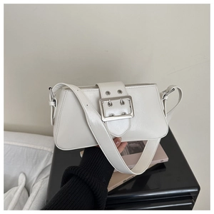 Close-up of white glossy PU leather underarm bag featuring a wide silver metal buckle