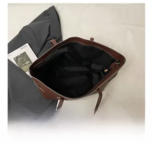 Top view of spacious interior in brown PU tote bag with a small zipper pocket