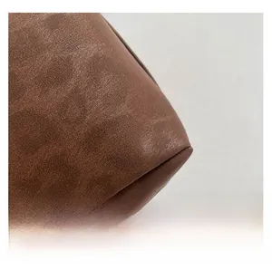Macro shot of high-quality dark brown leather texture with natural grain on minimalist bag
