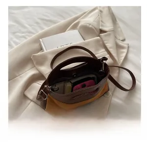 Detailed internal view of contrast color handbag showing large capacity for essentials