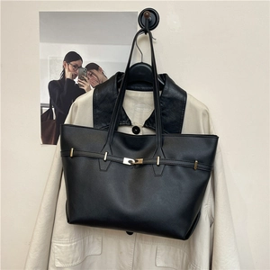Minimalist black leather tote bag with gold hardware and stylish shoulder straps