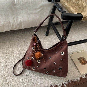 Dark brown suede tote bag with metal rivet rings and colorful pompom charms