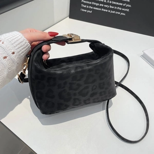 Chic black leopard print bucket bag with gold hardware and versatile crossbody strap