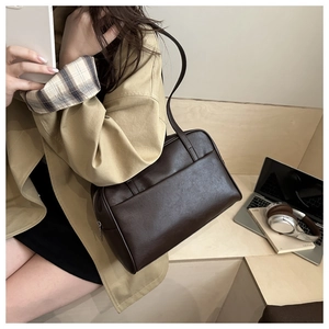 Detail of dark brown PU leather tote bag with large front pocket for daily commute