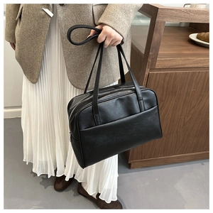 Detail view of large PU leather shoulder bag showing the exterior pocket and zipper