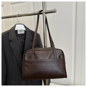 Detail view of large dark brown PU leather tote bag with front pocket and double straps