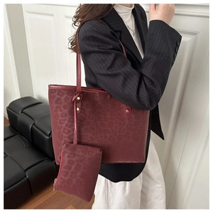 Detail of burgundy leopard print tote bag with a matching small zipper pouch attached