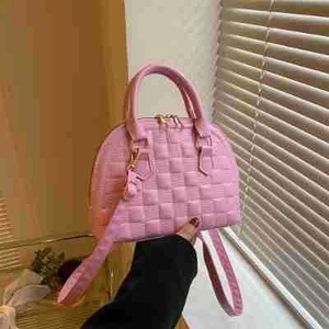 Pink quilted faux leather handbag with top handles and adjustable shoulder strap for women