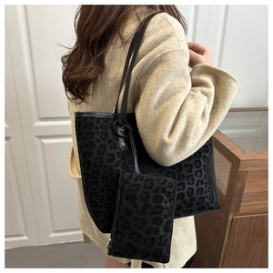 Detail view of large leopard print tote bag and matching pouch in soft velvet texture