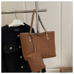 Detail of leopard print tote bag set with matching pouch and gold stud accents