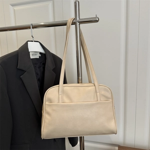 Minimalist beige PU leather tote bag with large front pocket and long shoulder straps