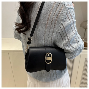 Sac bandoulière en cuir noir avec boucle dorée texturée et bandoulière réglable