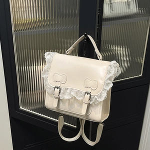 Sac à main crème avec bordure en dentelle et nœuds en cuir au design élégant