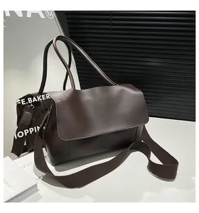 Detail view of coffee brown faux leather tote with wide strap and side accordion gussets