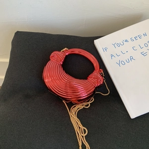 Red metallic gloss dumpling bag with acrylic circular handle and golden chain strap
