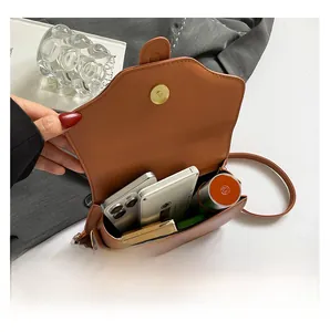 Macro view of the brown leather crossbody bag interior showing storage capacity