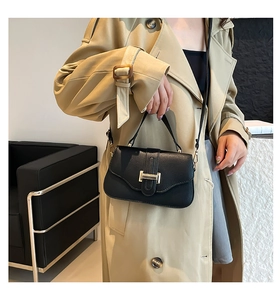 Chic black litchi pattern square bag with gold H-buckle shown on a trench coat model