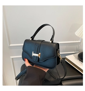 Close-up of black lychee grain leather handbag featuring a golden H-shaped hardware buckle