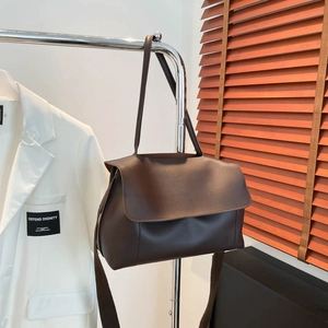 Large dark brown matte leather tote bag with flap closure and wide shoulder strap