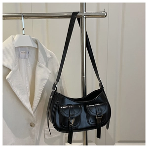 Detail of black semi-circular hobo bag with dual pockets and silver buckle hardware