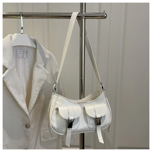 Detailed close-up of a white glossy PU leather shoulder bag with two front pockets