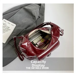 Interior view of large capacity burgundy patent leather tote showing ample storage space