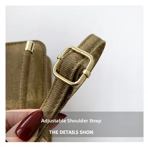 Detail of adjustable brown woven shoulder strap with polished gold metal buckle for bags
