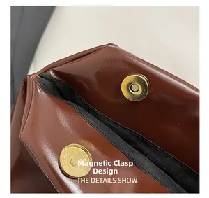 Detail of the magnetic buckle closure and high-quality lining on the brown leather bag