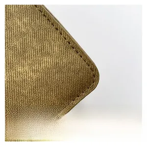 Detailed close-up of metallic bronze woven fabric and neat stitching on this commuter handbag