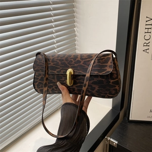 Leopard print baguette bag with gold lock shown in creative shadow lighting for women