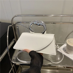 Minimalist white leather handbag featuring a unique silver metallic artistic handle for women