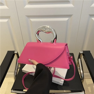 Rose red irregular handbag with silver heart handle and detachable strap in a trendy style