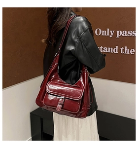 Close-up of deep red burgundy oil wax leather hobo bag with metal buckle detail