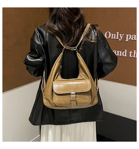Rear view of brown faux leather tote backpack worn as a stylish shoulder bag