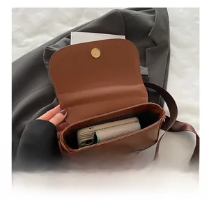 Internal view of the brown leather saddle bag showing storage capacity for daily essentials