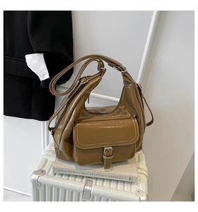 Detail showing the brown vintage polished leather tote with adjustable shoulder strap