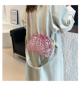 Detail of pink sequin cloud crossbody bag showing textured shimmer and pleated design