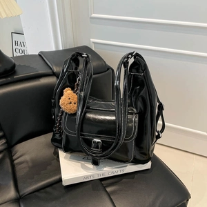 Minimalist black tote bag with white contrast stitching and cute brown bear pendant