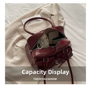 Deep red patent leather bag interior capacity showing phone, wallet and umbrella