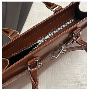 Macro detail of high-quality silver zipper closure on retro brown leather underarm bag