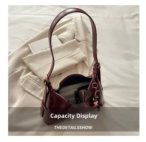 Interior view showing the large capacity and storage of the dark red leather hobo bag