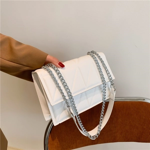 Chic white quilted crossbody bag with silver chain strap and geometric triangle pattern