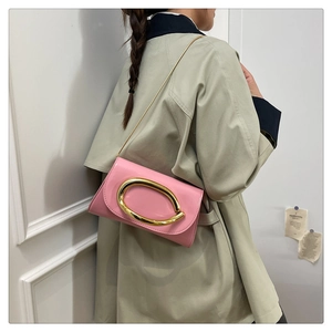 Pink patent leather crossbody bag with oversized gold oval buckle and chain strap