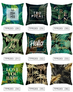Detail view of tropical plant pillow covers with palm leaf patterns and summer quotes