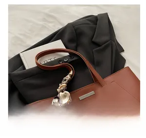 Brown leather tote bag featuring a floral scarf handle and Fashion & Bag lettering detail