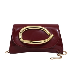 Classic dark red patent leather evening clutch with gold horsebit buckle and chain strap